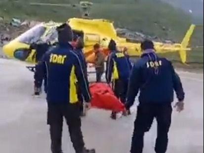 Due to ill health, the devotee was sent to the Higher Center by helicopter.