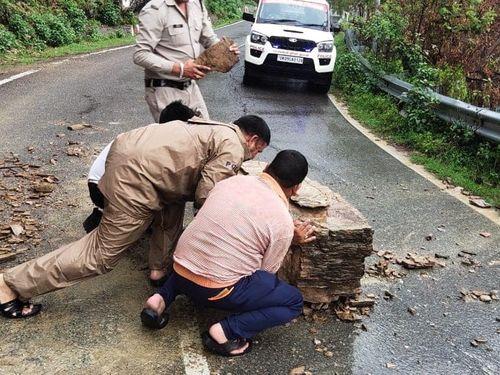 The boulders that came on the road due to heavy rain were removed by the police and local people.